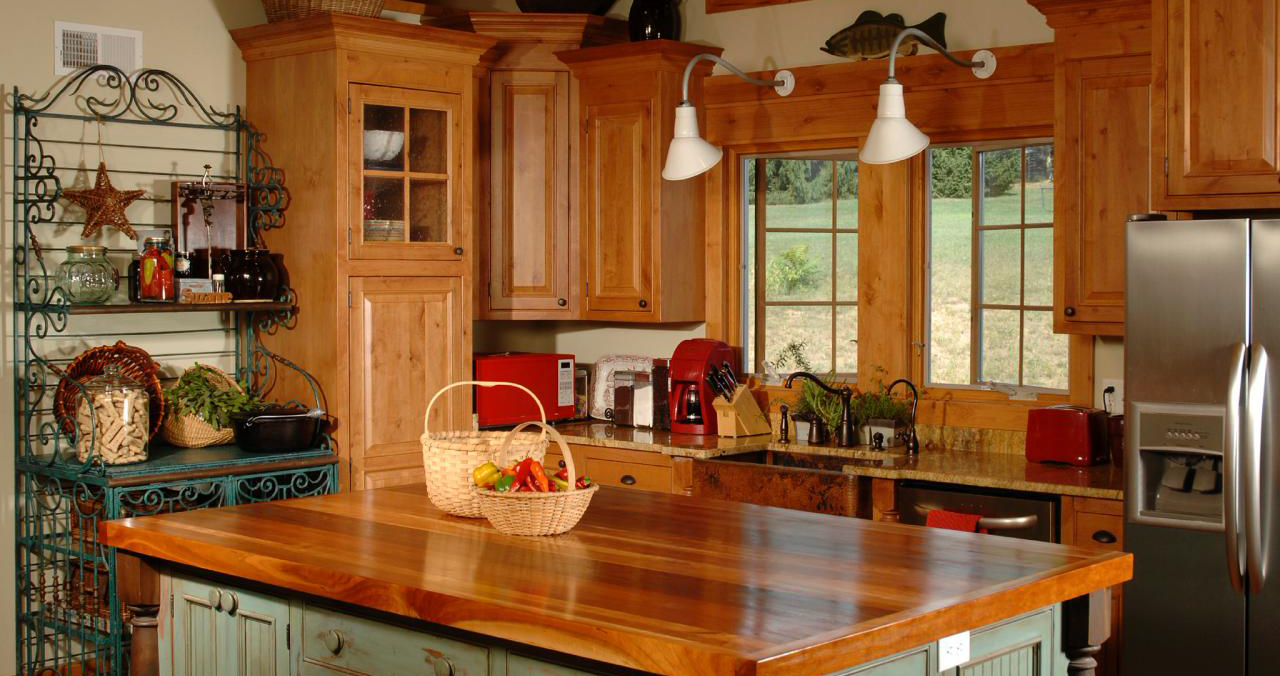 Beautiful interior of a home kitchen with stained wood cabinents.