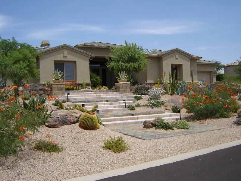 Beautifule home with a well thought out desert landscape for a yard.  Tile step walkway.